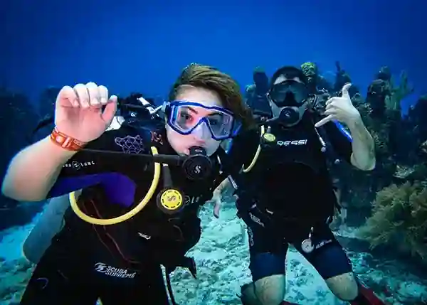 Father and daughter pose in front of the underwater museum in Cancun